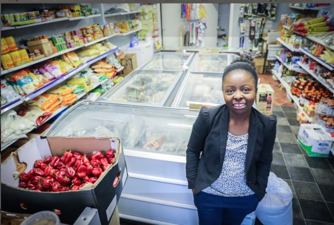Stephanie, owner of Domagai World Market, in the shop by the freezers